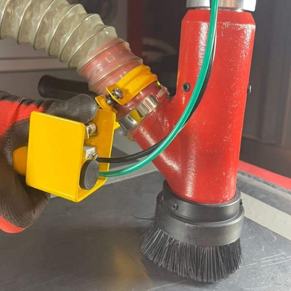 FEVI operator adjusting nozzle distance and angle during a sandblasting test